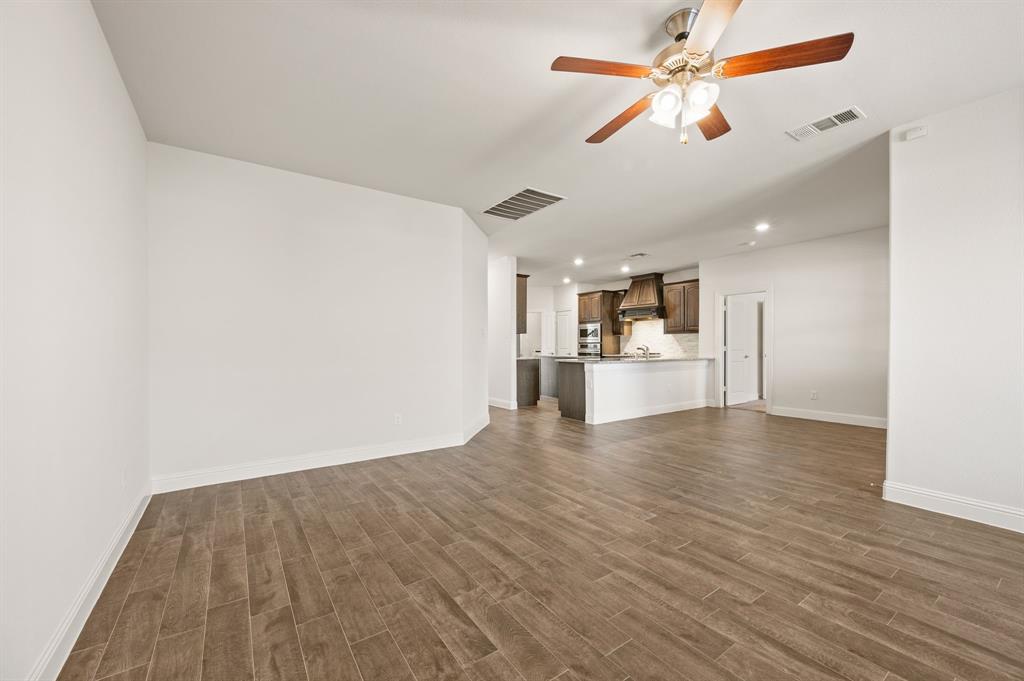 10920 Calvert Place McKinney, TX 75071 - Photo 8 of 37 a view of a kitchen with a dishwasher cabinets and wooden floor