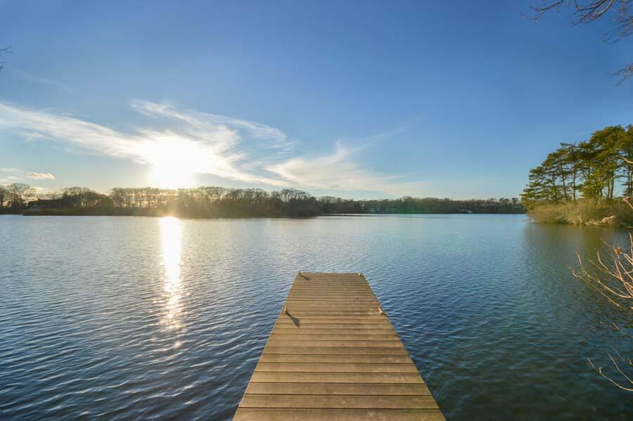 351 Huckins Neck Road Centerville, MA 02632 - Photo 15 of 55 a wooden pier with boats in a lake