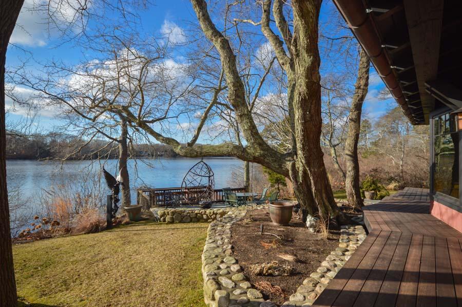 351 Huckins Neck Road Centerville, MA 02632 - Photo 17 of 55 a view of a yard with wooden fence