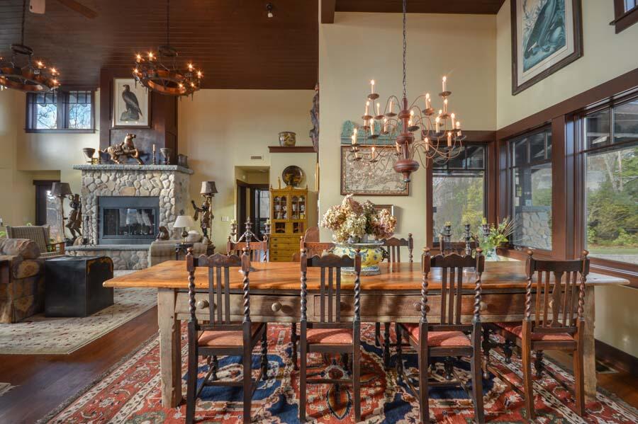 351 Huckins Neck Road Centerville, MA 02632 - Photo 28 of 55 a dining room with furniture a chandelier and fireplace