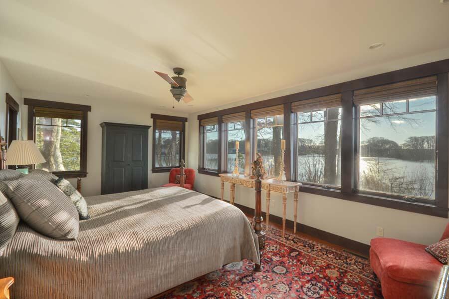 351 Huckins Neck Road Centerville, MA 02632 - Photo 33 of 55 a bedroom with a large bed and a large window