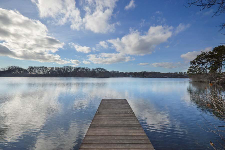 351 Huckins Neck Road Centerville, MA 02632 - Photo 45 of 55 a lake view with boat and trees in the background