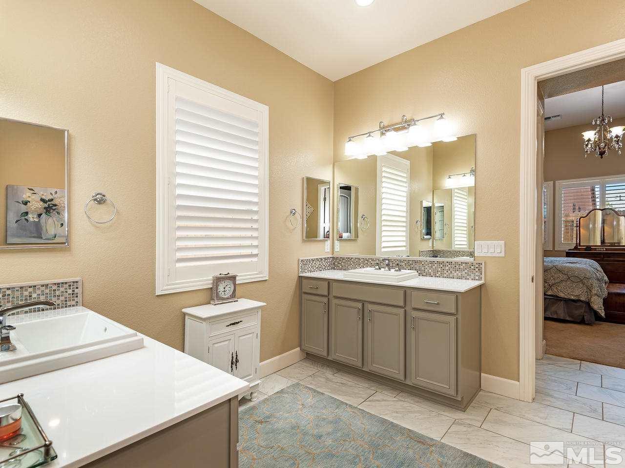 9455 Baldacci Road Reno, NV 89521 - Photo 16 of 22 a spacious bathroom with a granite countertop sink and a mirror