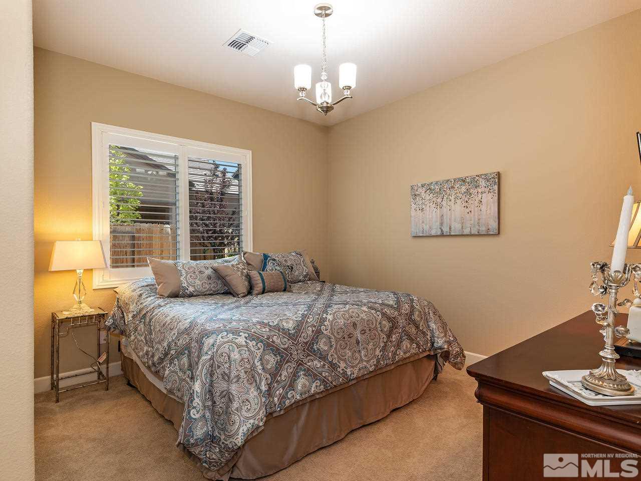 9455 Baldacci Road Reno, NV 89521 - Photo 20 of 22 a bedroom with a bed and a table in it