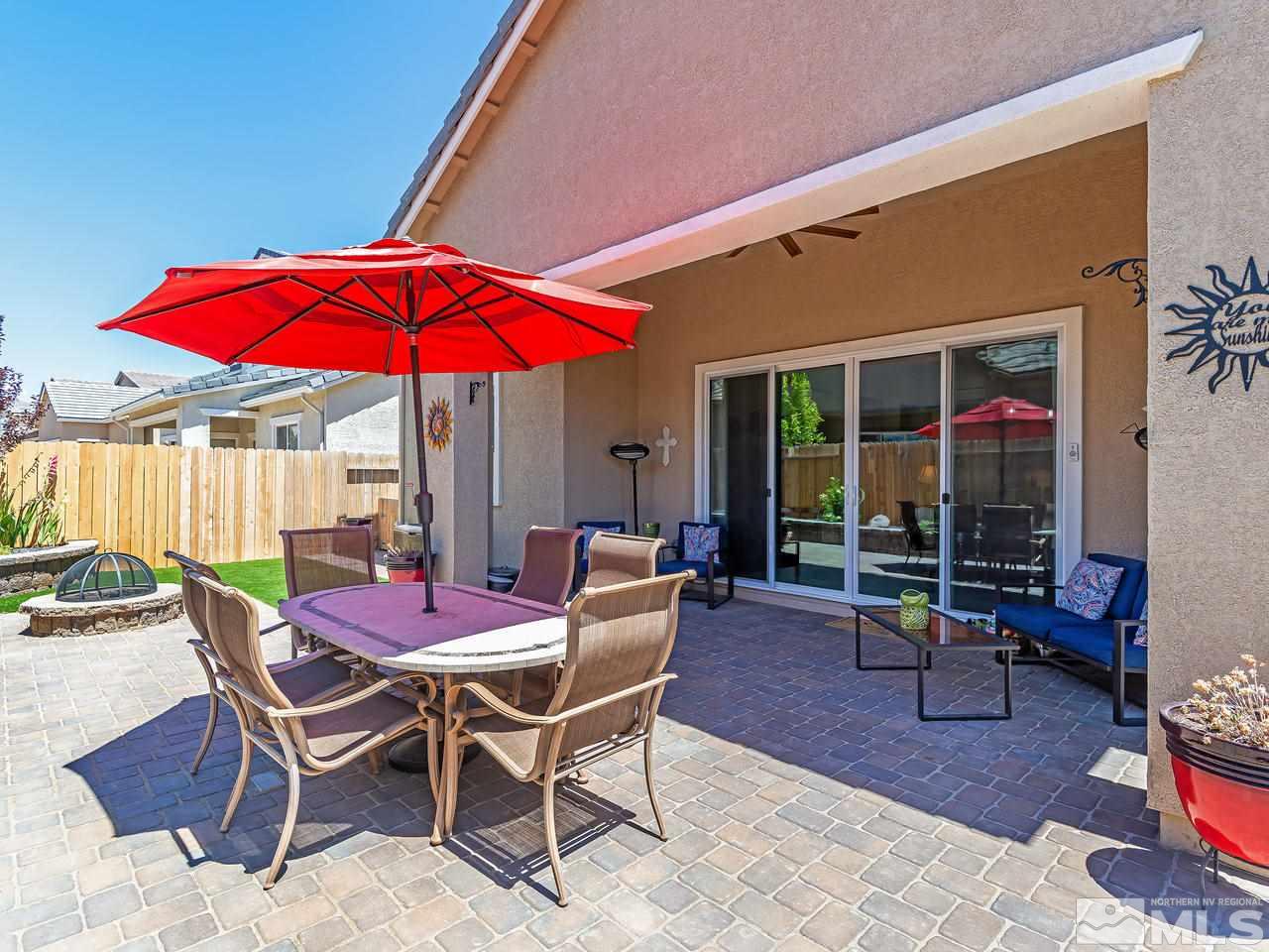 9455 Baldacci Road Reno, NV 89521 - Photo 5 of 22 a patio with a table and chairs under an umbrella