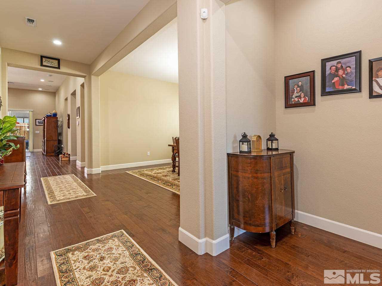 9455 Baldacci Road Reno, NV 89521 - Photo 6 of 22 a view of a hallway with wooden floor and furniture