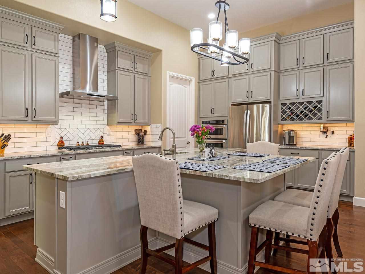 9455 Baldacci Road Reno, NV 89521 - Photo 9 of 22 a kitchen with granite countertop a sink stove and refrigerator