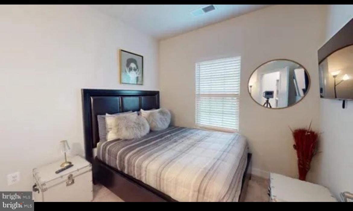 8002 General Greene Street Brandywine, MD 20613 - Photo 13 of 16 a bed room with a bed mirror and a wall