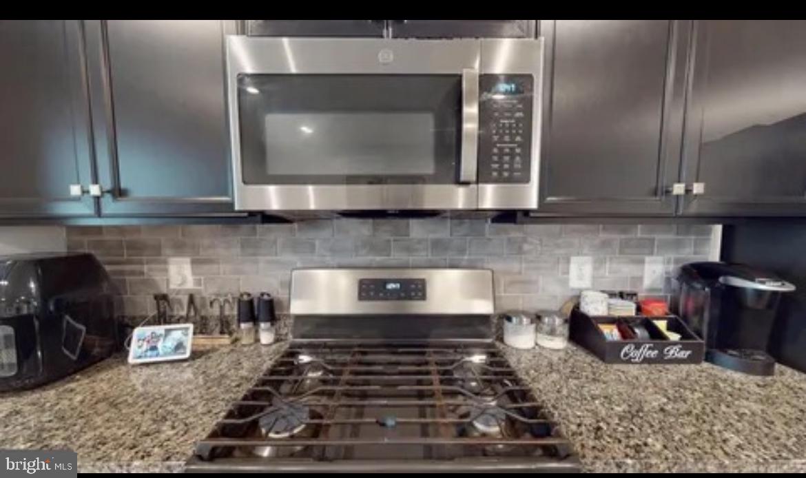 8002 General Greene Street Brandywine, MD 20613 - Photo 6 of 16 a kitchen with a stove and a white cabinets