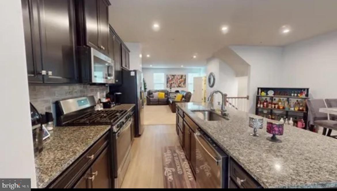 8002 General Greene Street Brandywine, MD 20613 - Photo 7 of 16 a kitchen with stainless steel appliances granite countertop counter top space a sink and cabinets