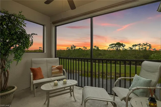 a balcony with furniture and a potted plant