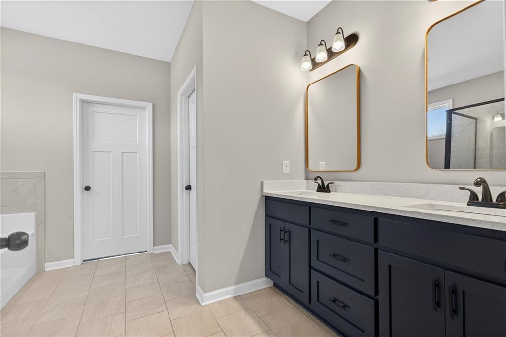 103 Hammond Road Griffin, GA 30223 - Photo 28 of 76 a bathroom with double vanity sinks and two mirror