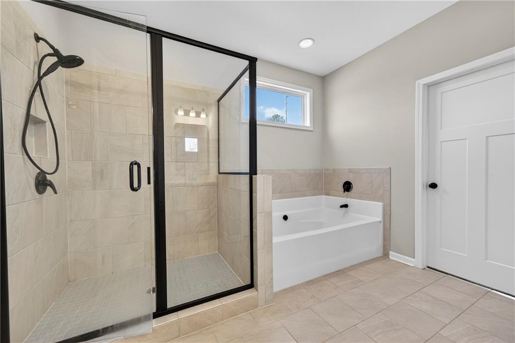 103 Hammond Road Griffin, GA 30223 - Photo 29 of 76 a bathroom with a bathtub and a shower