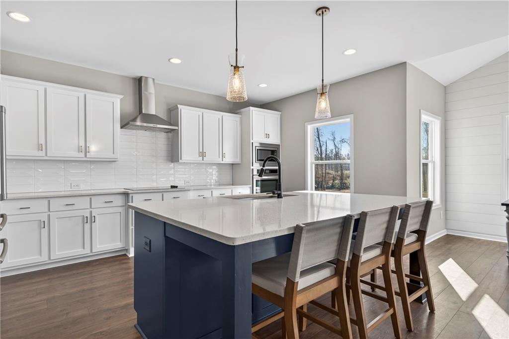 103 Hammond Road Griffin, GA 30223 - Photo 44 of 76 a kitchen with a dining table chairs sink and cabinets
