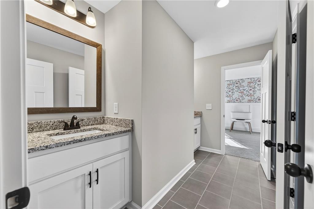 103 Hammond Road Griffin, GA 30223 - Photo 59 of 76 a en suite bathroom with a granite countertop sink mirror and a toilet