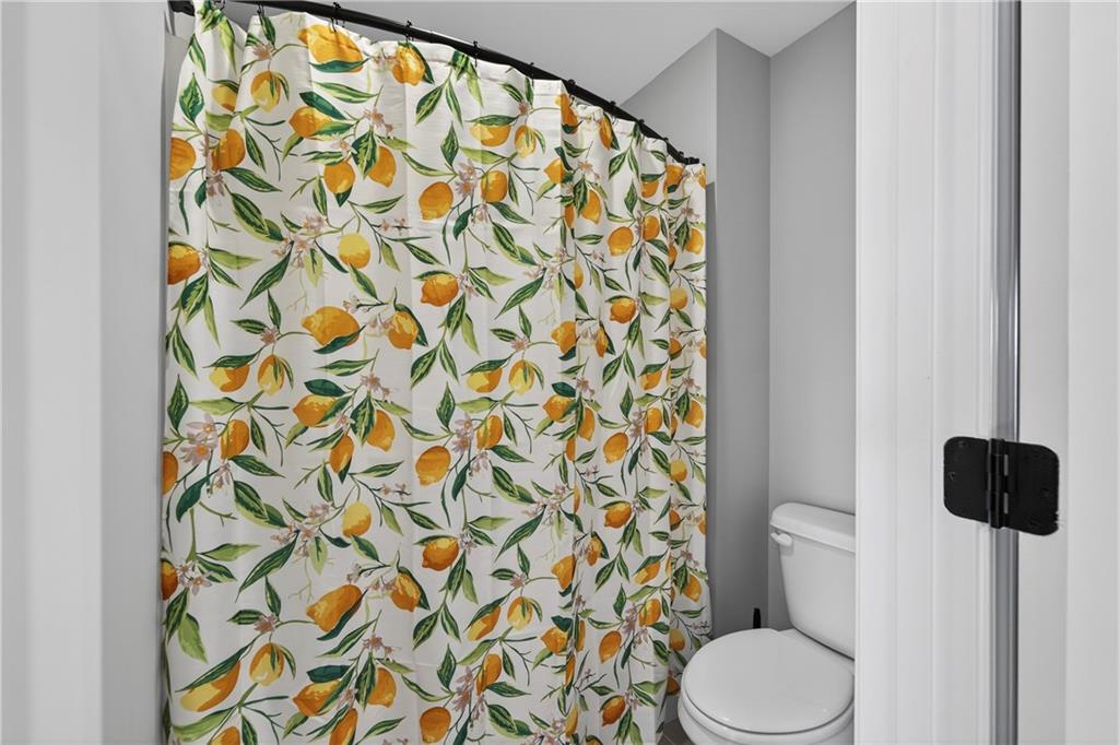 103 Hammond Road Griffin, GA 30223 - Photo 60 of 76 a bathroom with a toilet and a shower curtain