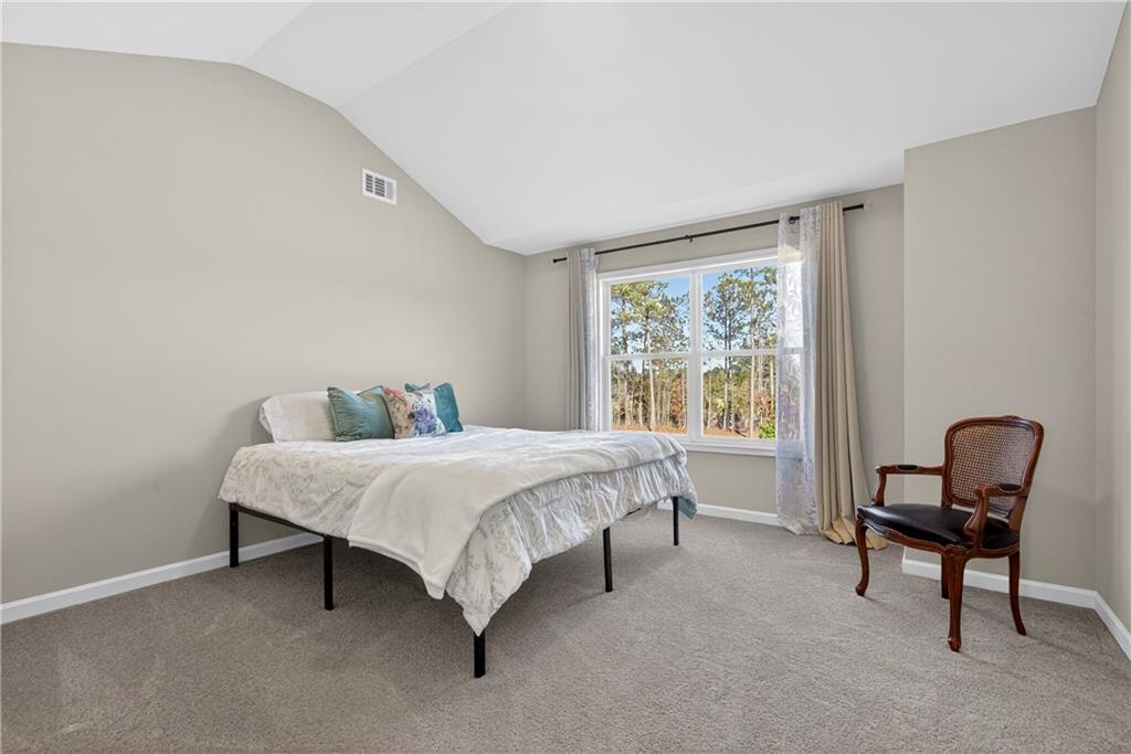 103 Hammond Road Griffin, GA 30223 - Photo 64 of 76 a bed sitting in a room next to a window