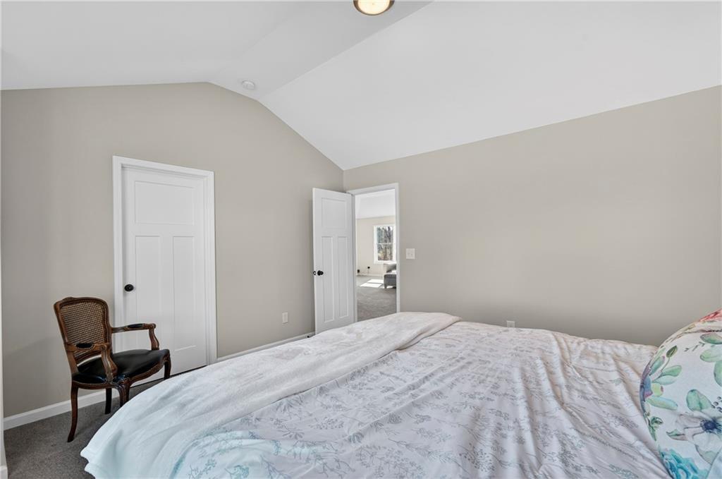 103 Hammond Road Griffin, GA 30223 - Photo 65 of 76 a bedroom with a bed and a chair