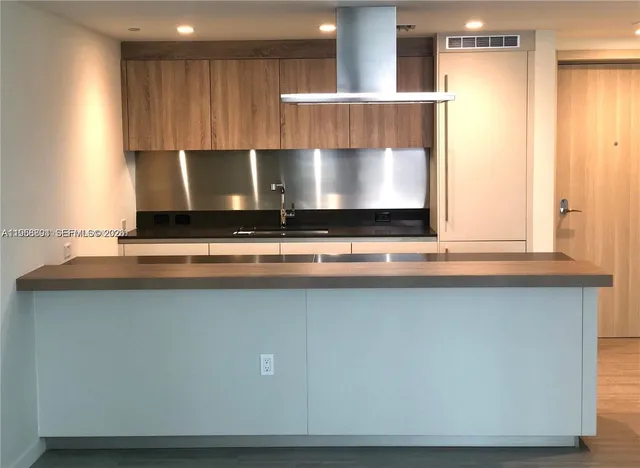 a kitchen with a sink a stove and a microwave