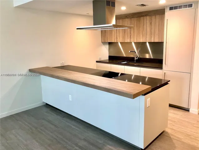 a kitchen with a cabinets and wooden floor