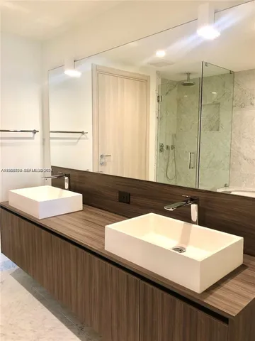 a bathroom with a sink double vanity and a bathtub