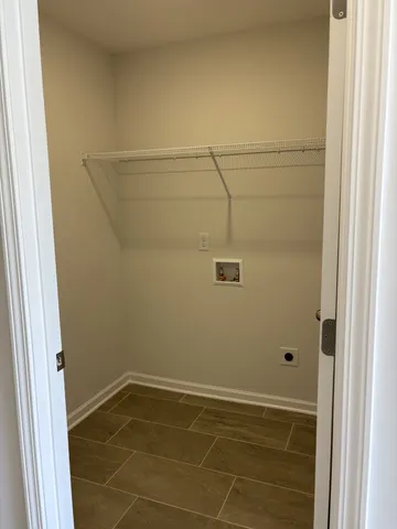 an empty room with ceiling fan and window