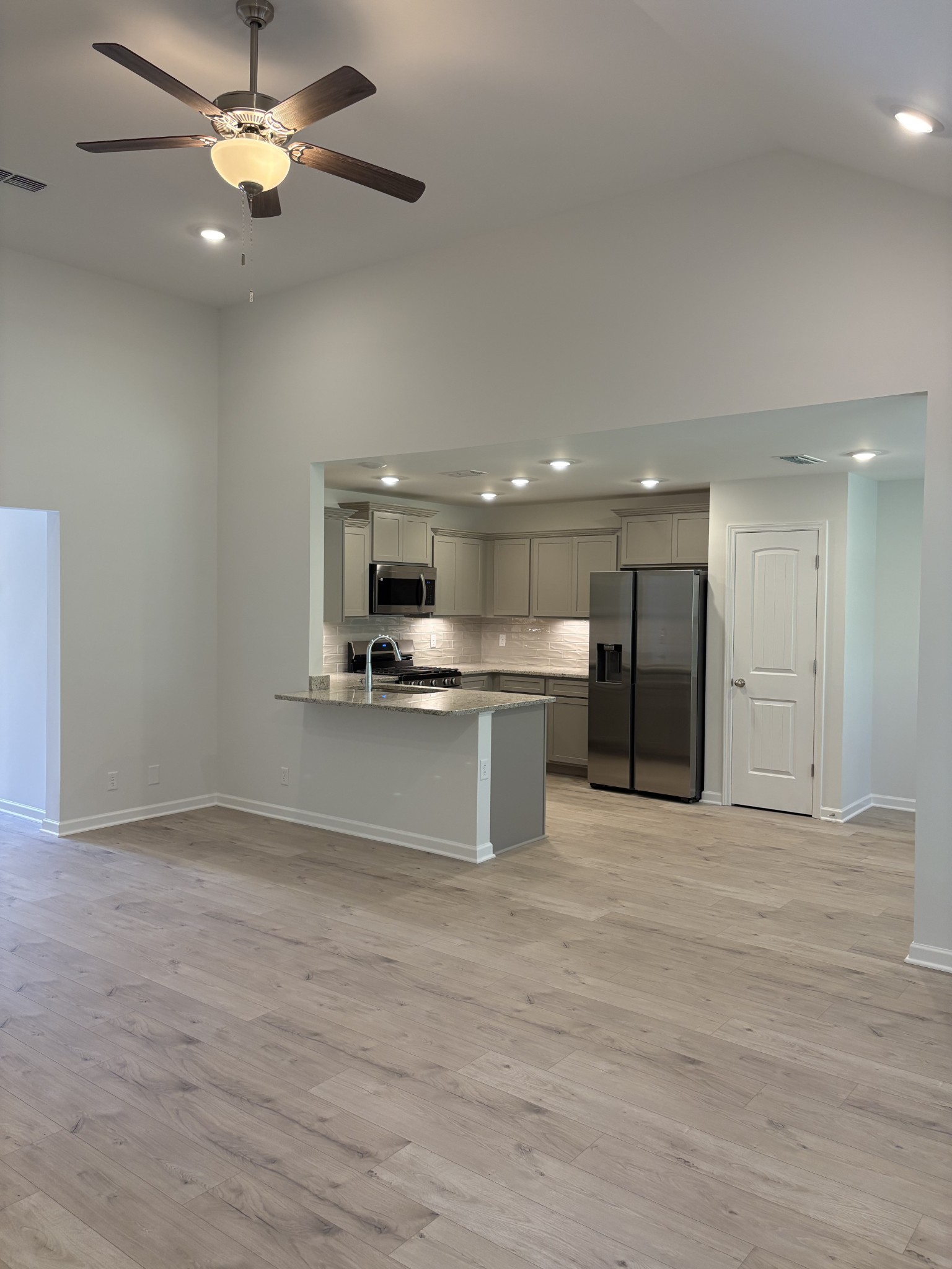 5730 Craven Lane Rockvale, TN 37153 - Photo 13 of 27 a view of kitchen with kitchen island stainless steel appliances refrigerator stove top oven and cabinets