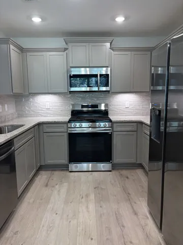 a utility room with a sink a vanity and mirror