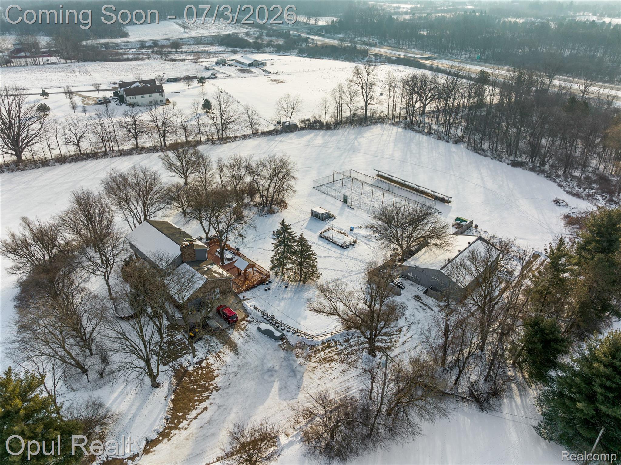 8855 Gross Road Dexter, MI 48130 - Photo 12 of 53 Spacious property featuring a primary residence, a large outbuilding, and expansive snow-covered grounds