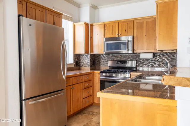 a kitchen with a refrigerator sink and stove