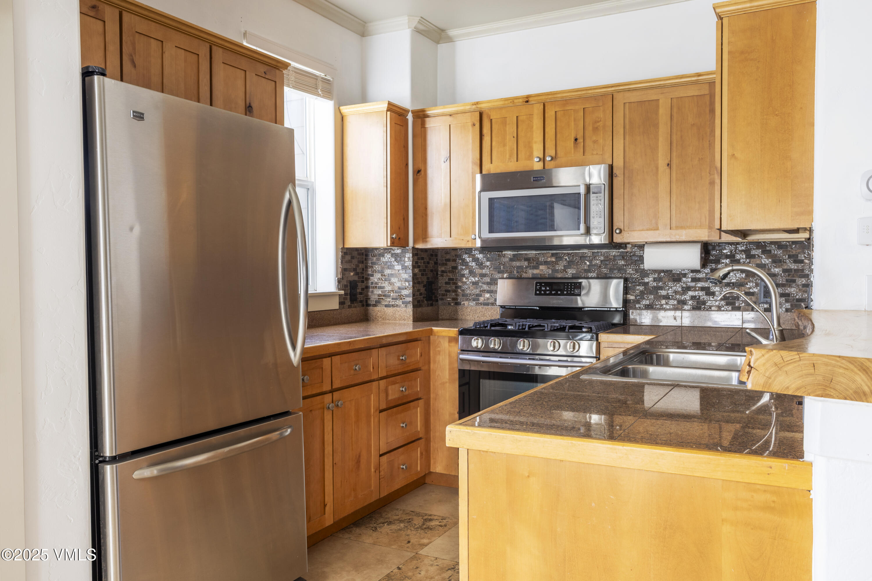 20 MacDonald Street Eagle, CO 81631 - Photo 3 of 10 a kitchen with a refrigerator sink and stove