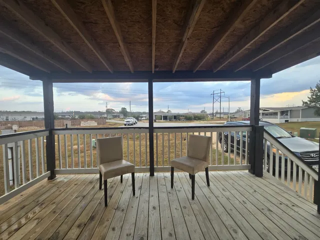 a view of a balcony with wooden floor
