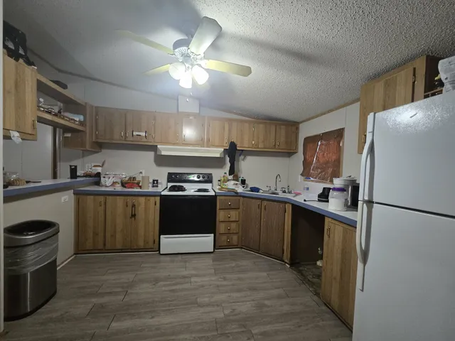 a kitchen with a refrigerator a stove top oven a sink and dishwasher