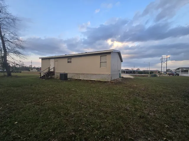 a backyard of a house with lots of green space and garden