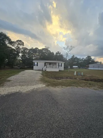 a view of house with outdoor space and lakeside
