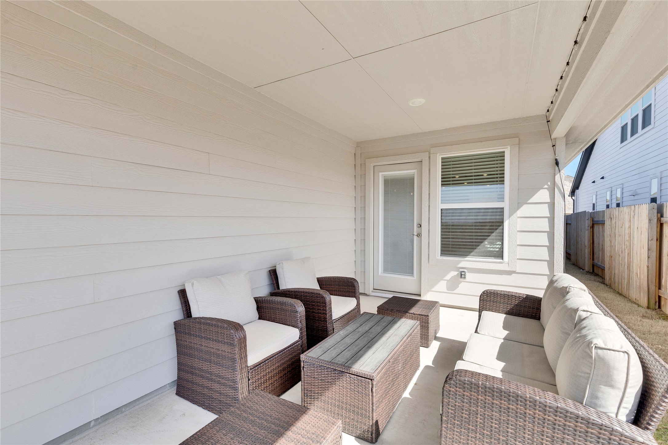 12308 Dairywork Road Buda, TX 78610 - Photo 5 of 24 The covered back patio extends the home’s living space outdoors.