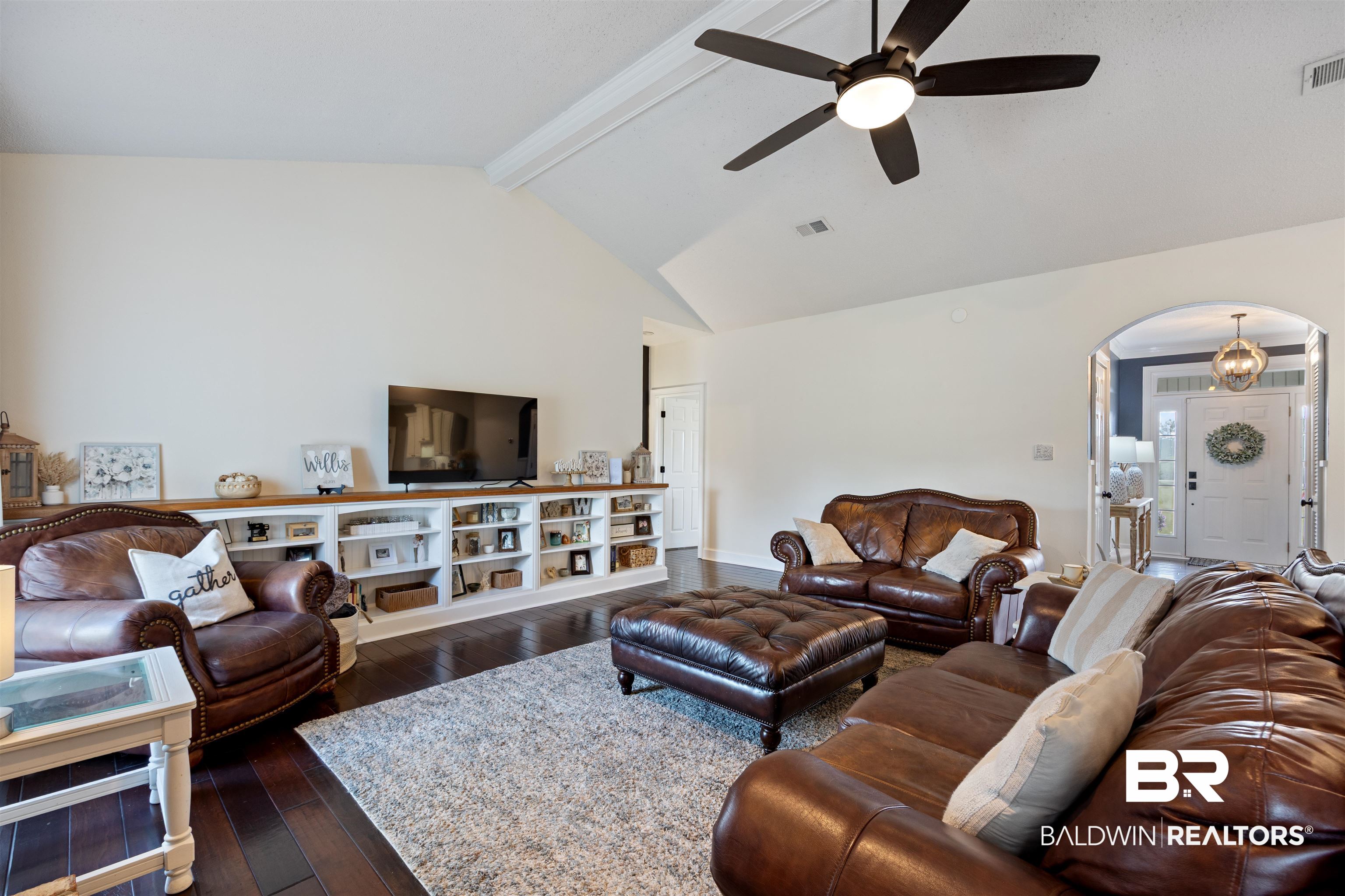 9855 Stucki Road Elberta, AL 36530 - Photo 15 of 54 Living room featuring arched walkways, dark wood-style floors, and ceiling fan