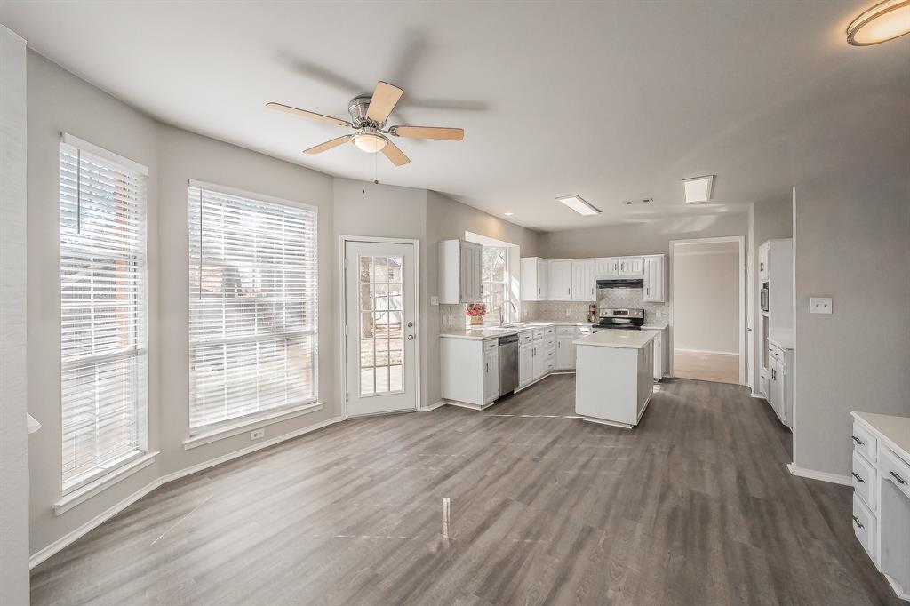 1803 Haydenbend Circle Grapevine, TX 76051 - Photo 16 of 40 Breakfast area is open to the kitchen & family room. Luxury vinyl wood flooring offers easy care & cleaning. Lots of windows for plenty of natural light!