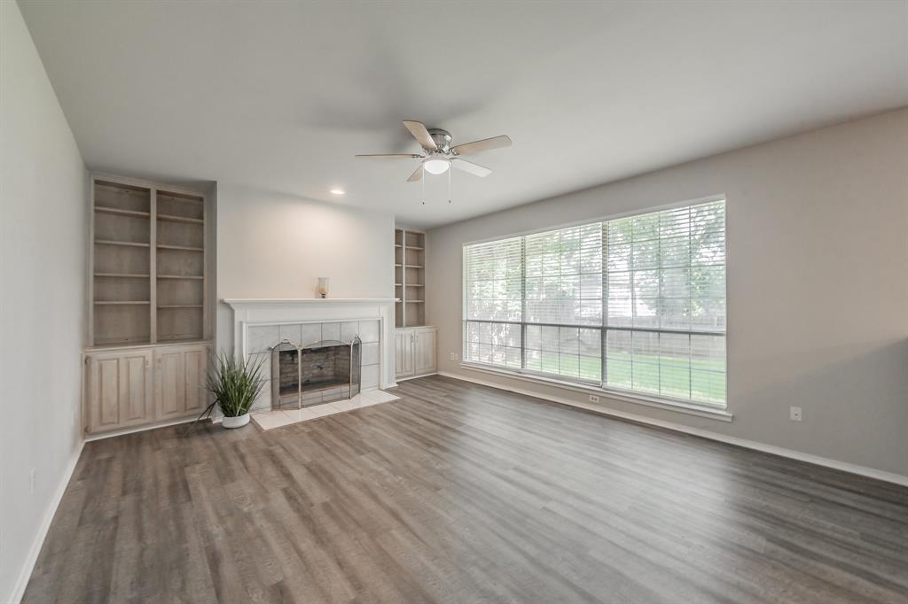 1803 Haydenbend Circle Grapevine, TX 76051 - Photo 18 of 40 Family room with wood burning fireplace ready for cozy evenings is flanked by built in shelves & cabinets for added storage.