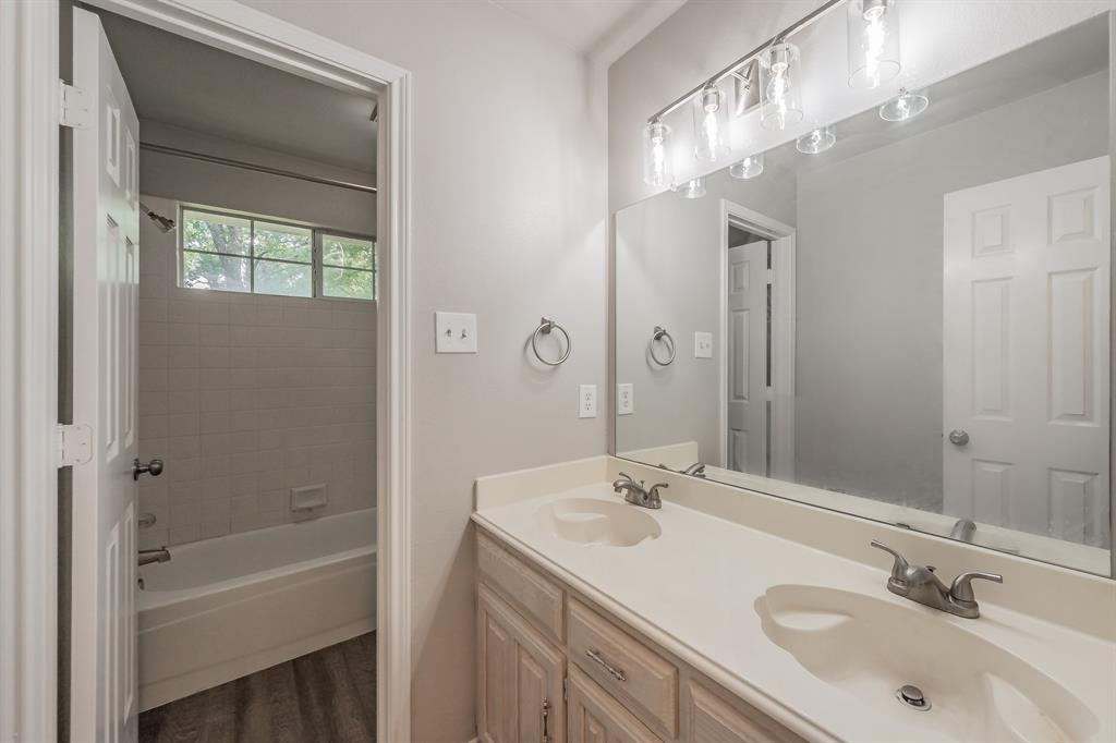 1803 Haydenbend Circle Grapevine, TX 76051 - Photo 29 of 40 Guest bathroom on 2nd floor with double sinks & updated lighting and faucets.