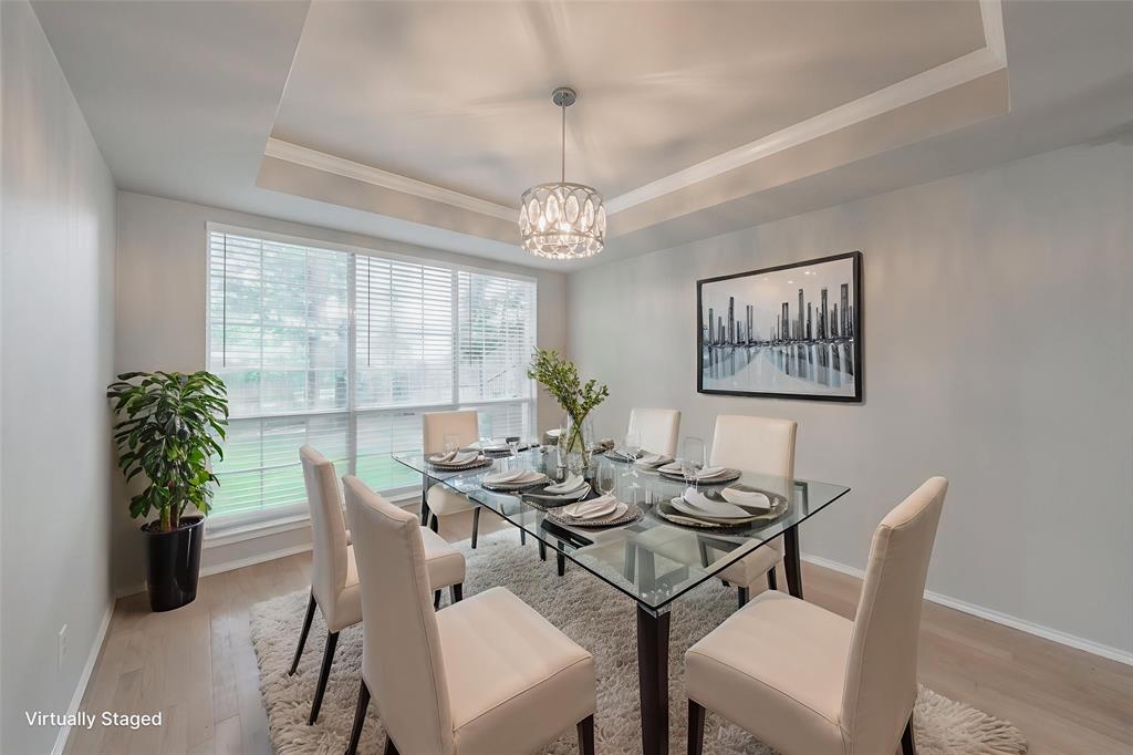 1803 Haydenbend Circle Grapevine, TX 76051 - Photo 10 of 40 Dining area with a tray ceiling, wood finished floors, a chandelier, and ornamental molding
