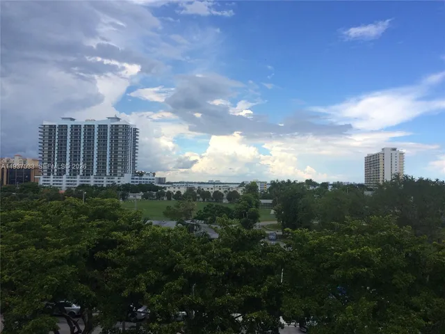 a view of a city with lush green forest