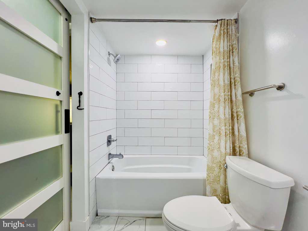 12311 Braxfield Court, Unit 425 Rockville, MD 20852 - Photo 11 of 22 a bathroom with a toilet and a bathtub