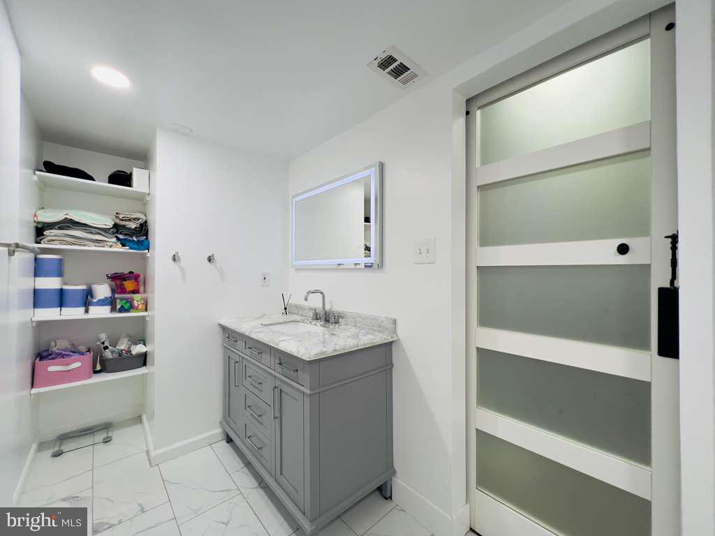 12311 Braxfield Court, Unit 425 Rockville, MD 20852 - Photo 12 of 22 a bathroom with a sink a toilet and vanity