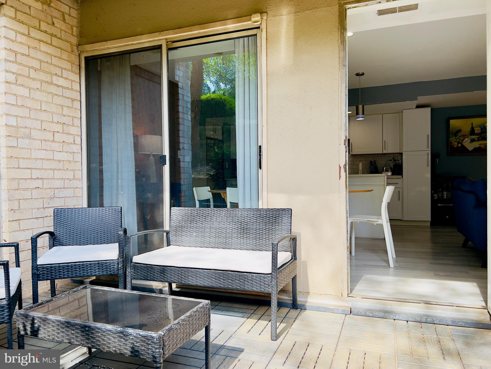 12311 Braxfield Court, Unit 425 Rockville, MD 20852 - Photo 13 of 22 a outdoor space with patio the couches and a dining table with garden view