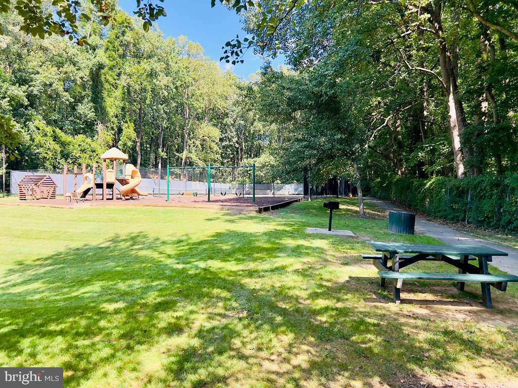 12311 Braxfield Court, Unit 425 Rockville, MD 20852 - Photo 17 of 22 a view of a park with swings and a bench