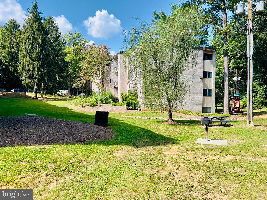 12311 Braxfield Court, Unit 425 Rockville, MD 20852 - Photo 19 of 22 a view of a park with swings and slides