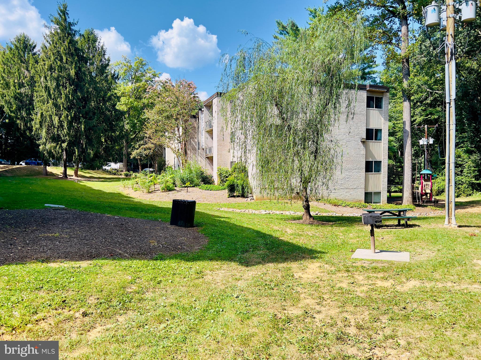 12311 Braxfield Court, Unit 425 Rockville, MD 20852 - Photo 20 of 22 a view of a park with swings and slides
