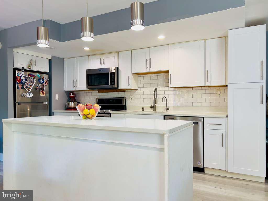 12311 Braxfield Court, Unit 425 Rockville, MD 20852 - Photo 4 of 22 a kitchen with stainless steel appliances a stove refrigerator sink and cabinets