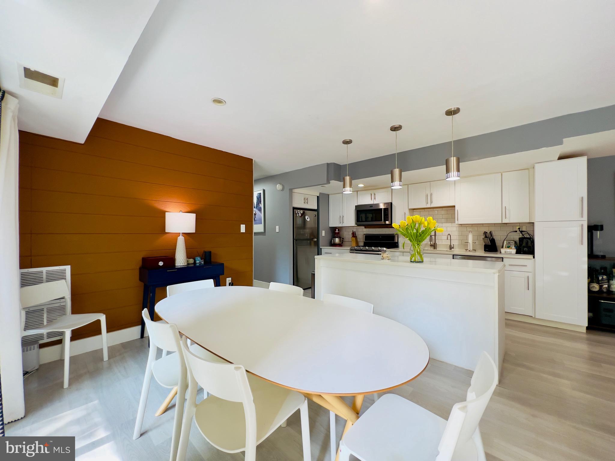 12311 Braxfield Court, Unit 425 Rockville, MD 20852 - Photo 6 of 22 a kitchen with a table and chairs in it